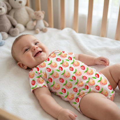 Mockup of a happy baby wearing a onesie printed with the cute kawaii peach and strawberry summer pattern.