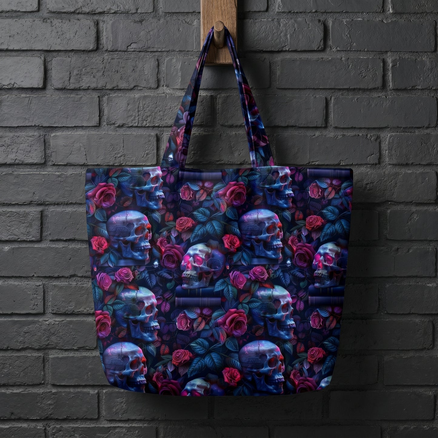 Mockup of a black canvas tote bag hanging on a brick wall, printed with a gothic skull and rose seamless pattern.