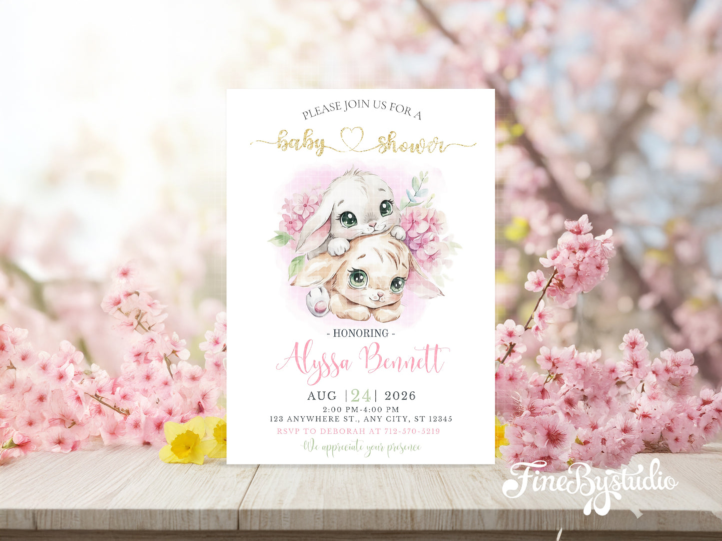 Whimsical baby shower invitation featuring two cute watercolor bunnies surrounded by pink cherry blossoms and gold glitter text.

