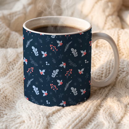 White coffee mug featuring a festive navy blue winter floral pattern with red berries.
