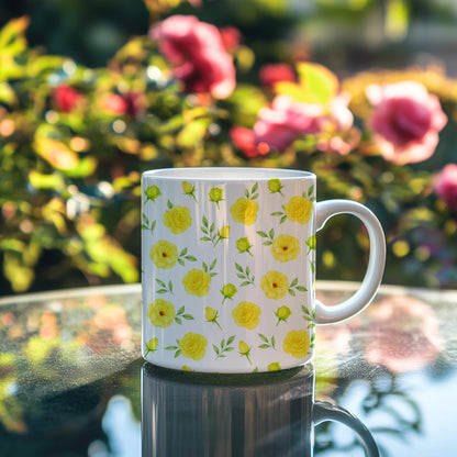 A white ceramic mug featuring a bright yellow floral seamless pattern standing on a reflective table in a garden.