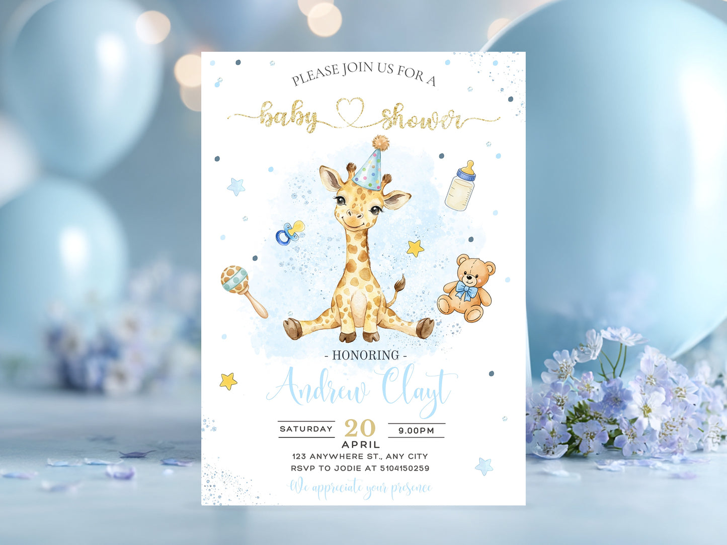 Mockup of a blue watercolor baby shower invitation featuring a cute sitting giraffe and gold glitter text on a table with blue flowers.
