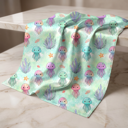 Pastel ocean jellyfish seamless pattern printed on soft nursery fabric mockup.