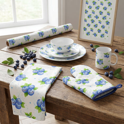 Kitchen table setting with a table runner, oven mitt, and mug featuring a cheerful kawaii blueberry pattern.