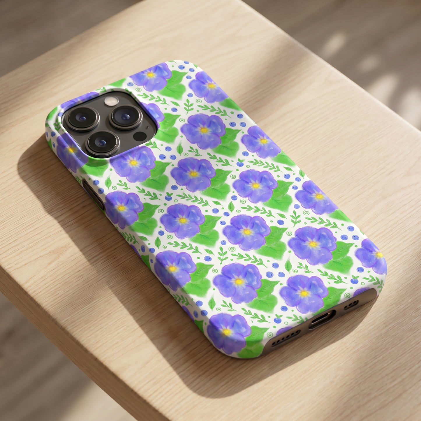 Phone case and tote bag showcasing a vibrant purple botanical seamless design.
