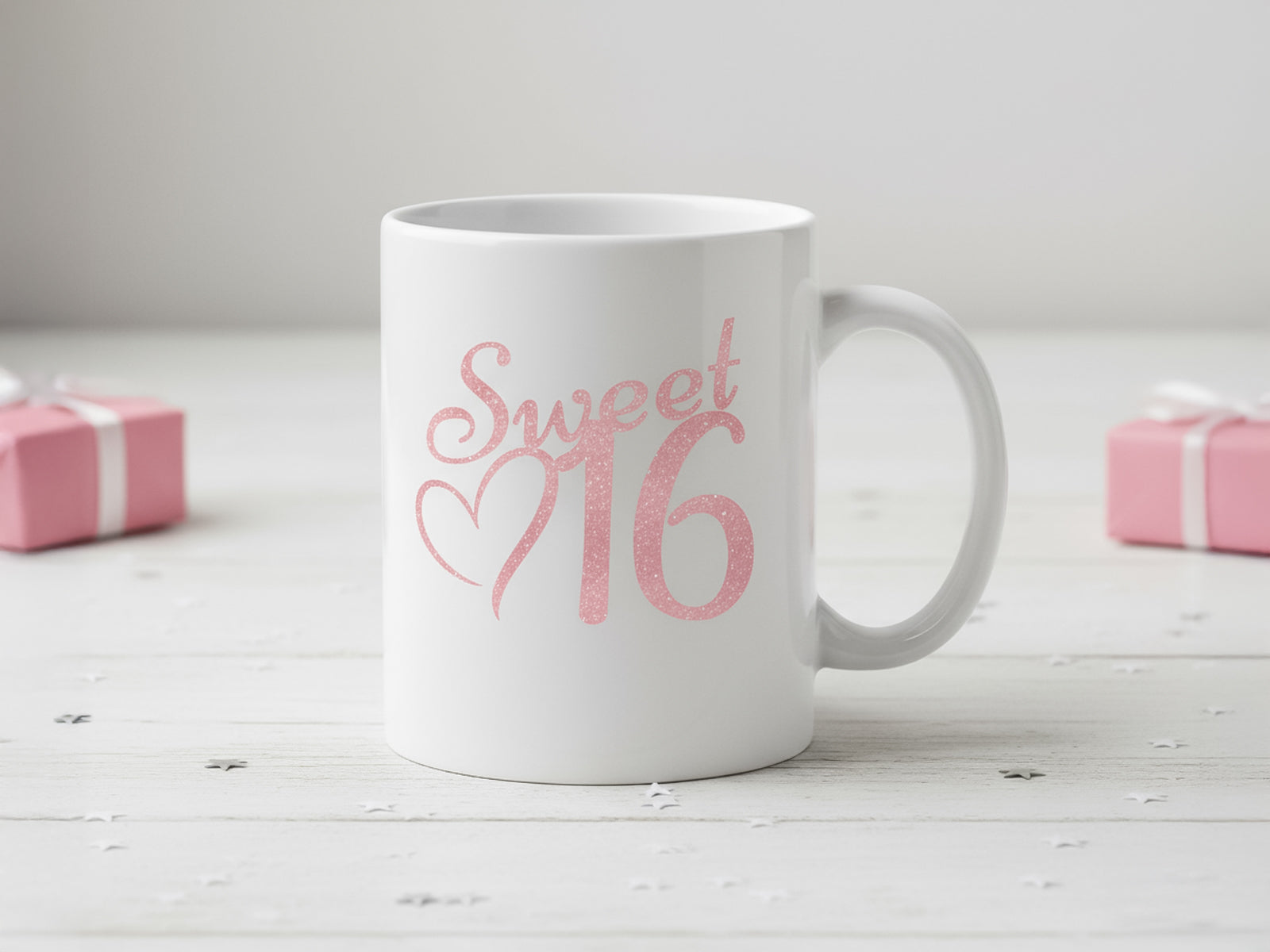 White ceramic mug with a pink "Sweet 16" print, birthday gift idea.
