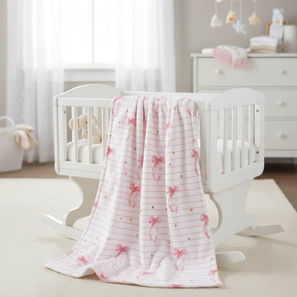 A white baby crib with a blanket featuring a pink bow seamless pattern.